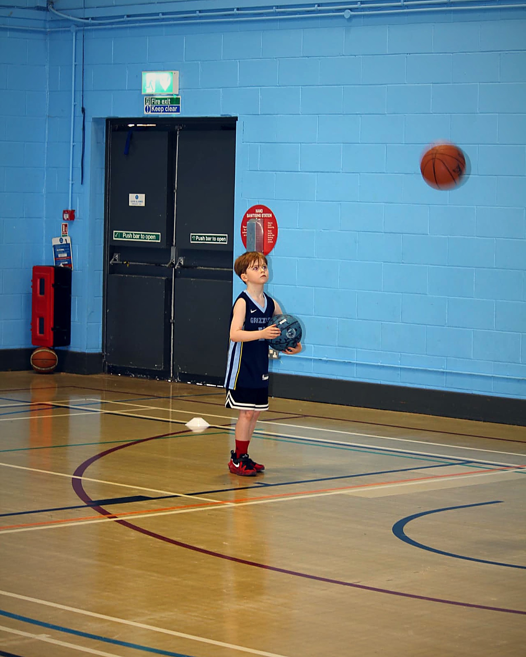 A young primary-age participant preparing to shoot during a PHB session