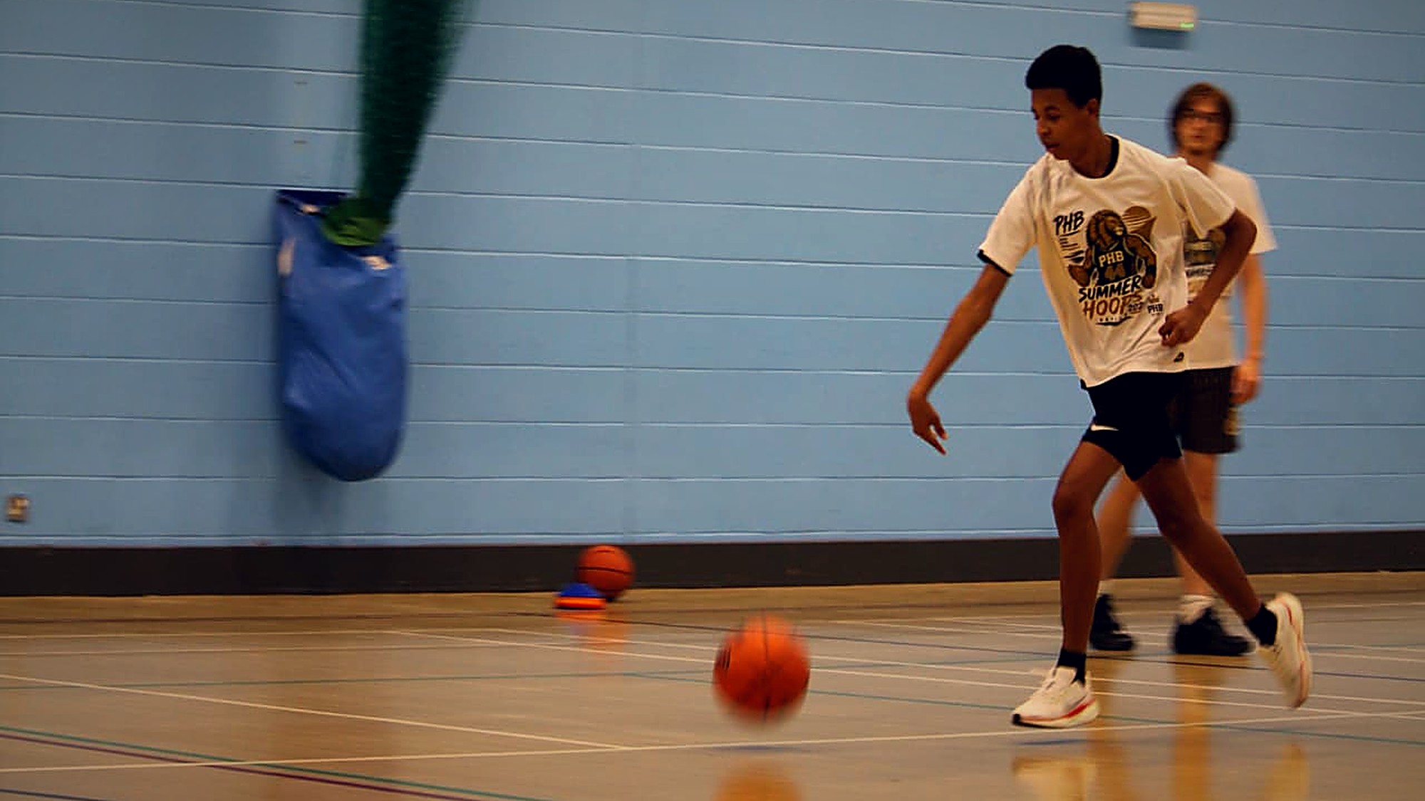 Participants completing a dribbling drill in a PHB session
